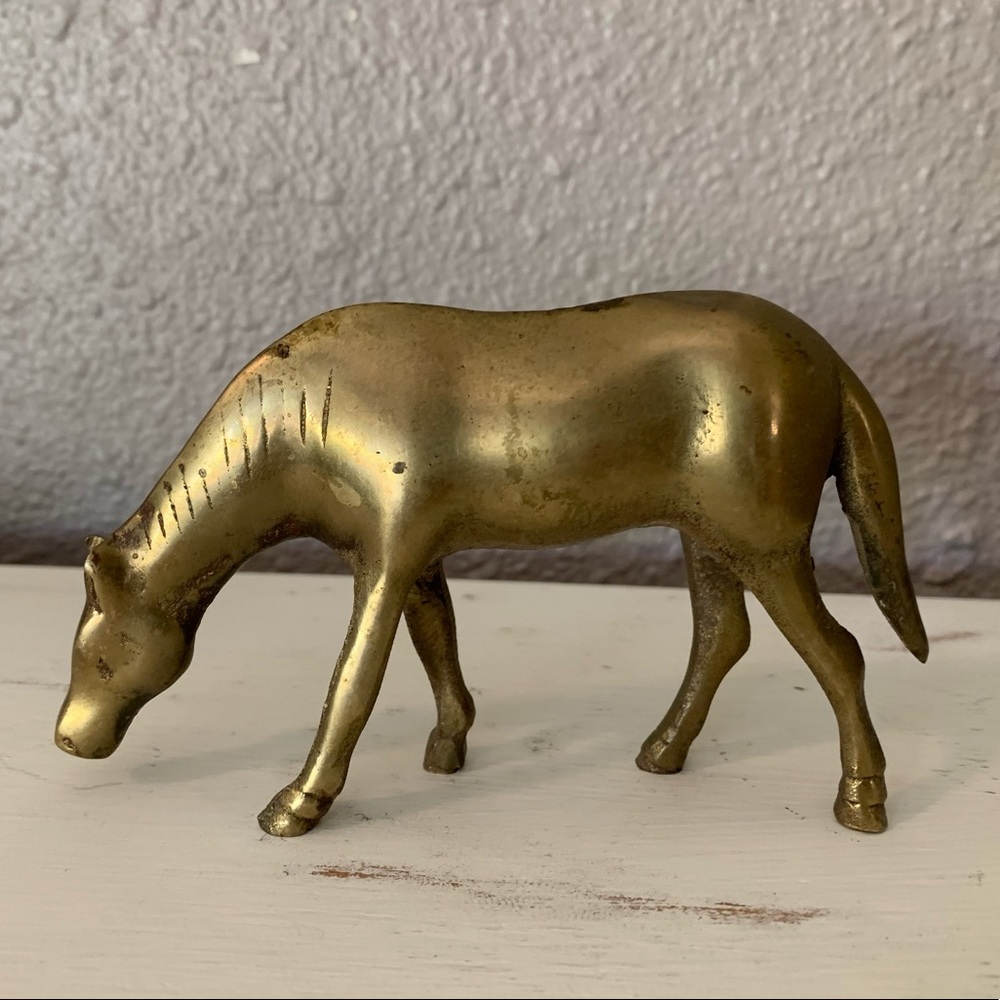 Vintage solid brass grazing horse.